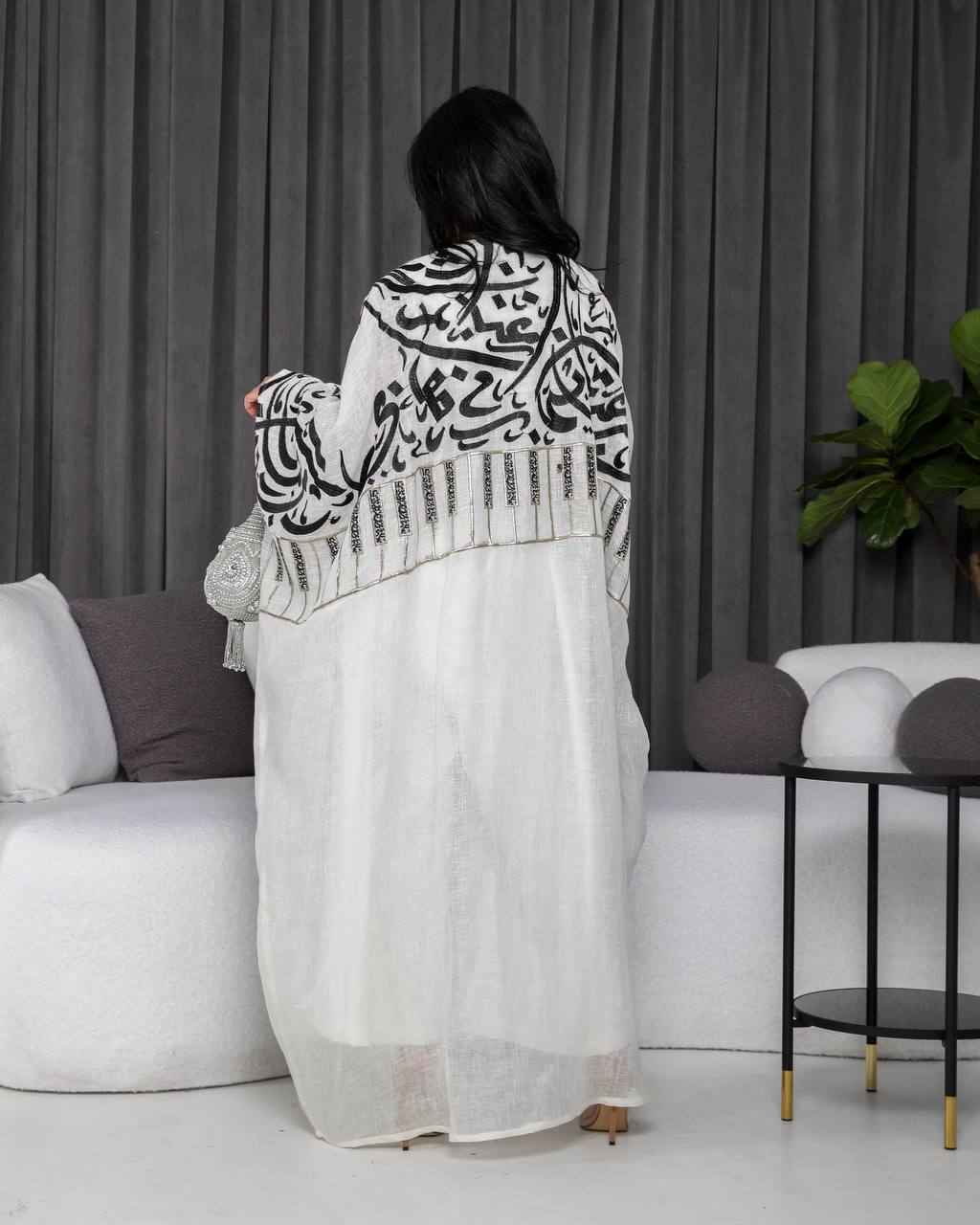 A white bisht with embroidery.C;1055